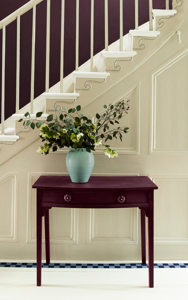Tyrian Purple painted table against a cream staircase backdrop